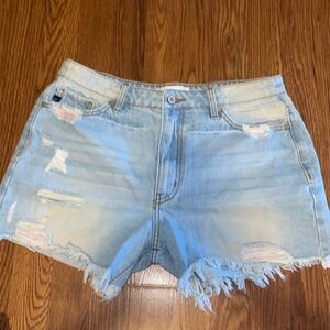Light denim shorts with colored details in the distressed parts
